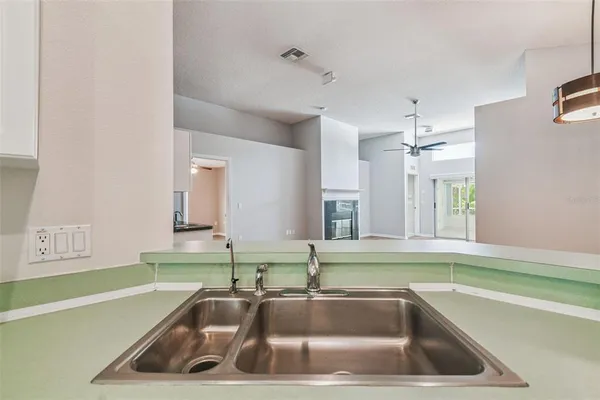 a view of a kitchen with a stove top oven