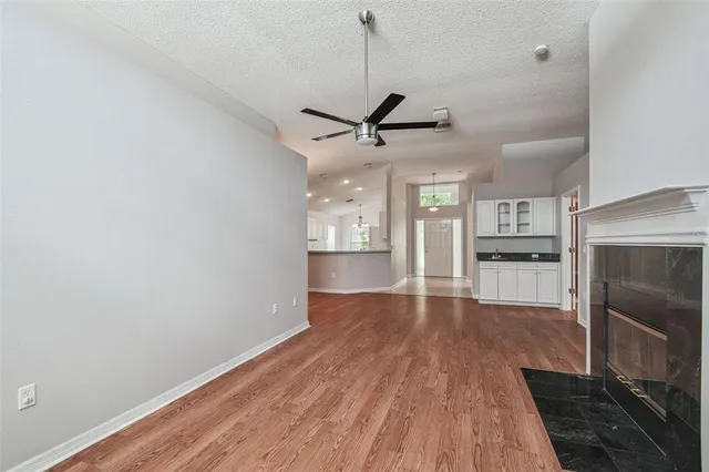 a view of an empty room with a ceiling fan