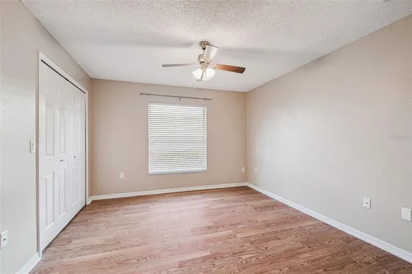 a view of an empty room with a balcony and chandelier