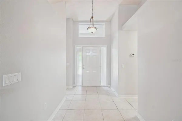 a view of a hallway with wooden floor and a living room
