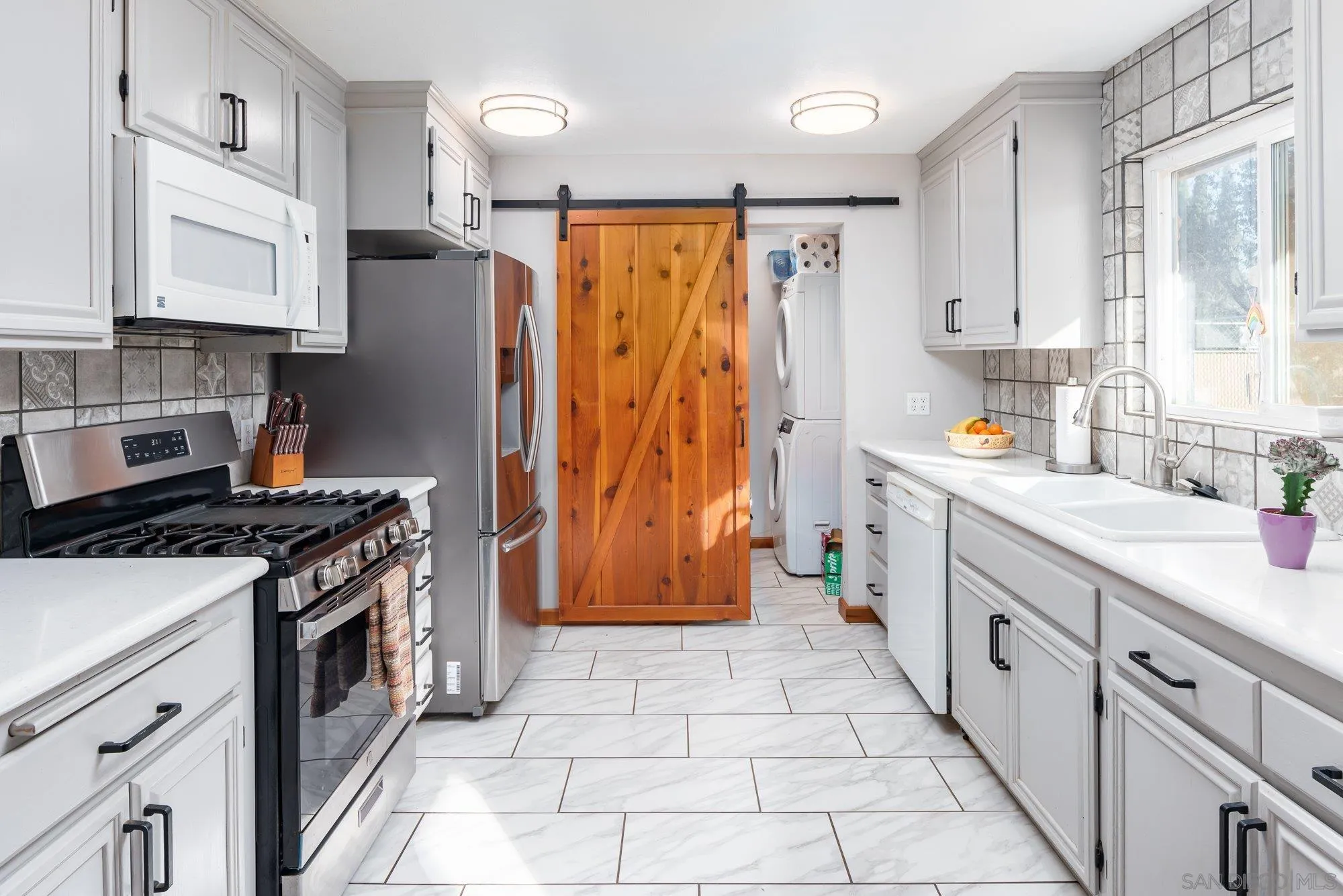 1241 Marshall Road Alpine, CA 91901 - Photo 5 of 21 a kitchen with stainless steel appliances granite countertop a stove top oven a sink dishwasher and a refrigerator with wooden cabinets