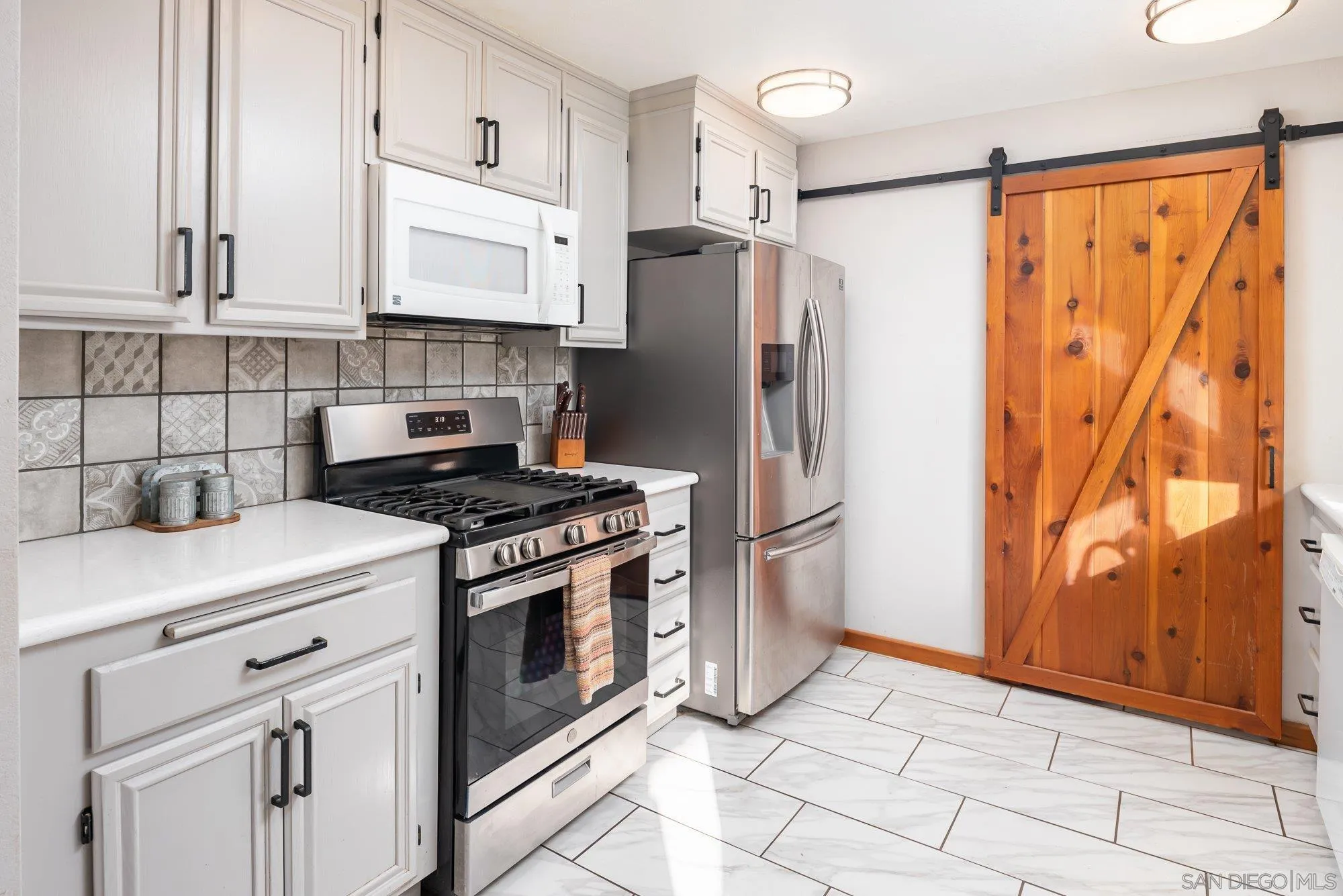 1241 Marshall Road Alpine, CA 91901 - Photo 6 of 21 a kitchen with stainless steel appliances a refrigerator sink and cabinets