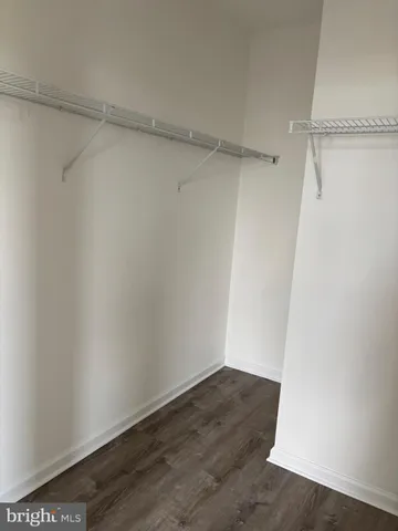 a bathroom with a granite countertop sink and a toilet
