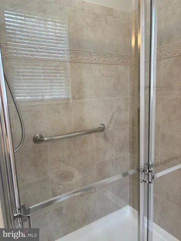a bathroom with a glass shower door