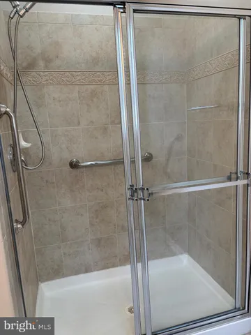 a bathroom with a glass shower door