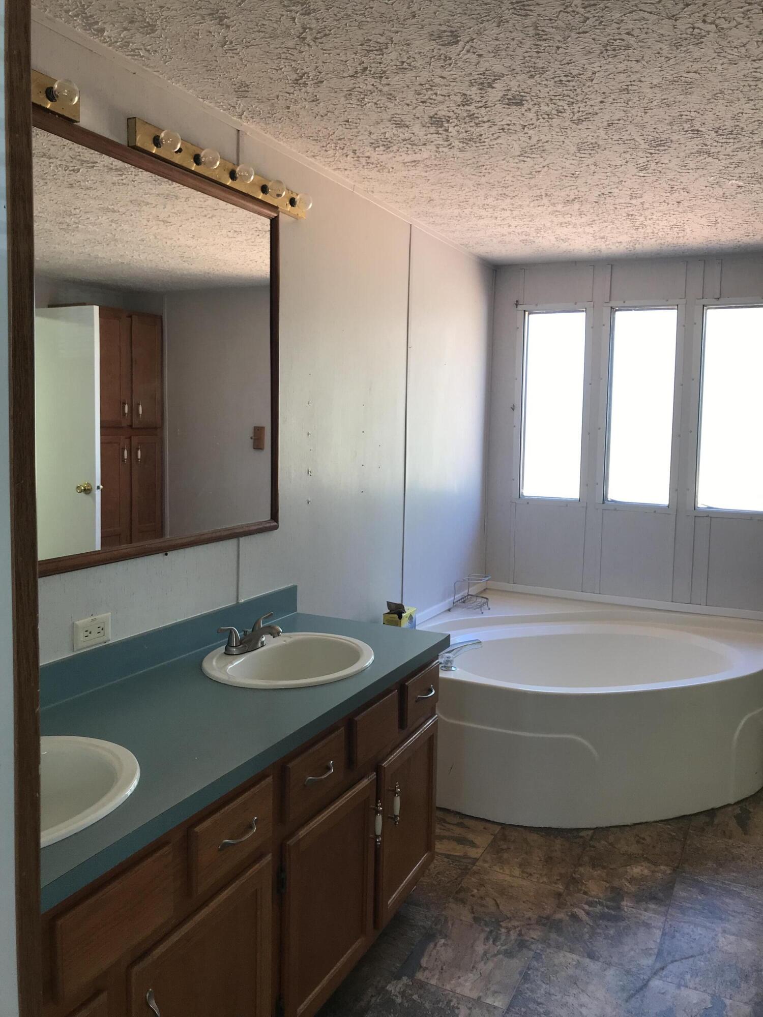 5806 Bush Road Baker, FL 32531 - Photo 12 of 17 a bathroom with a tub sink and mirror