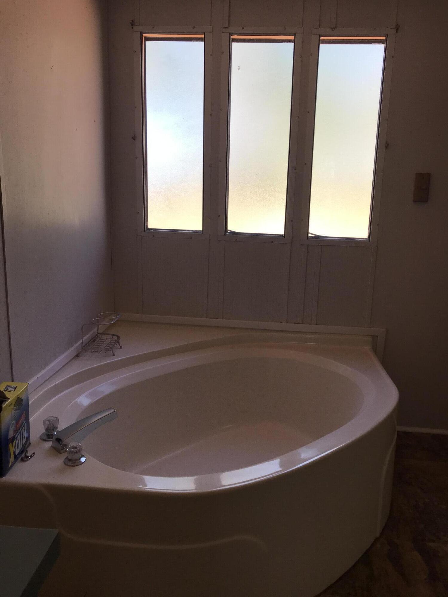 5806 Bush Road Baker, FL 32531 - Photo 13 of 17 a bath tub sitting in a bathroom next to a window