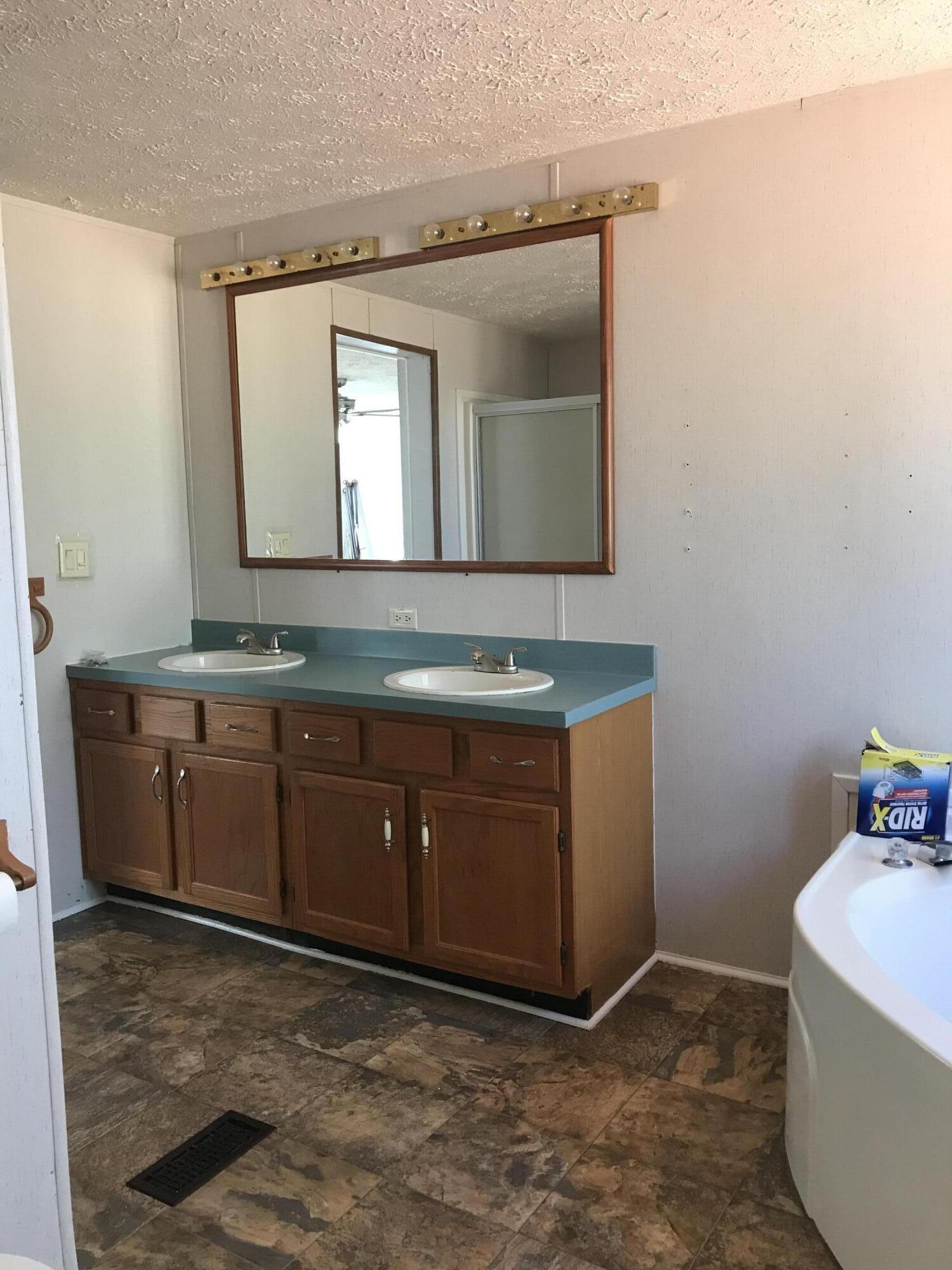 5806 Bush Road Baker, FL 32531 - Photo 16 of 17 a bathroom with a granite countertop sink and a mirror