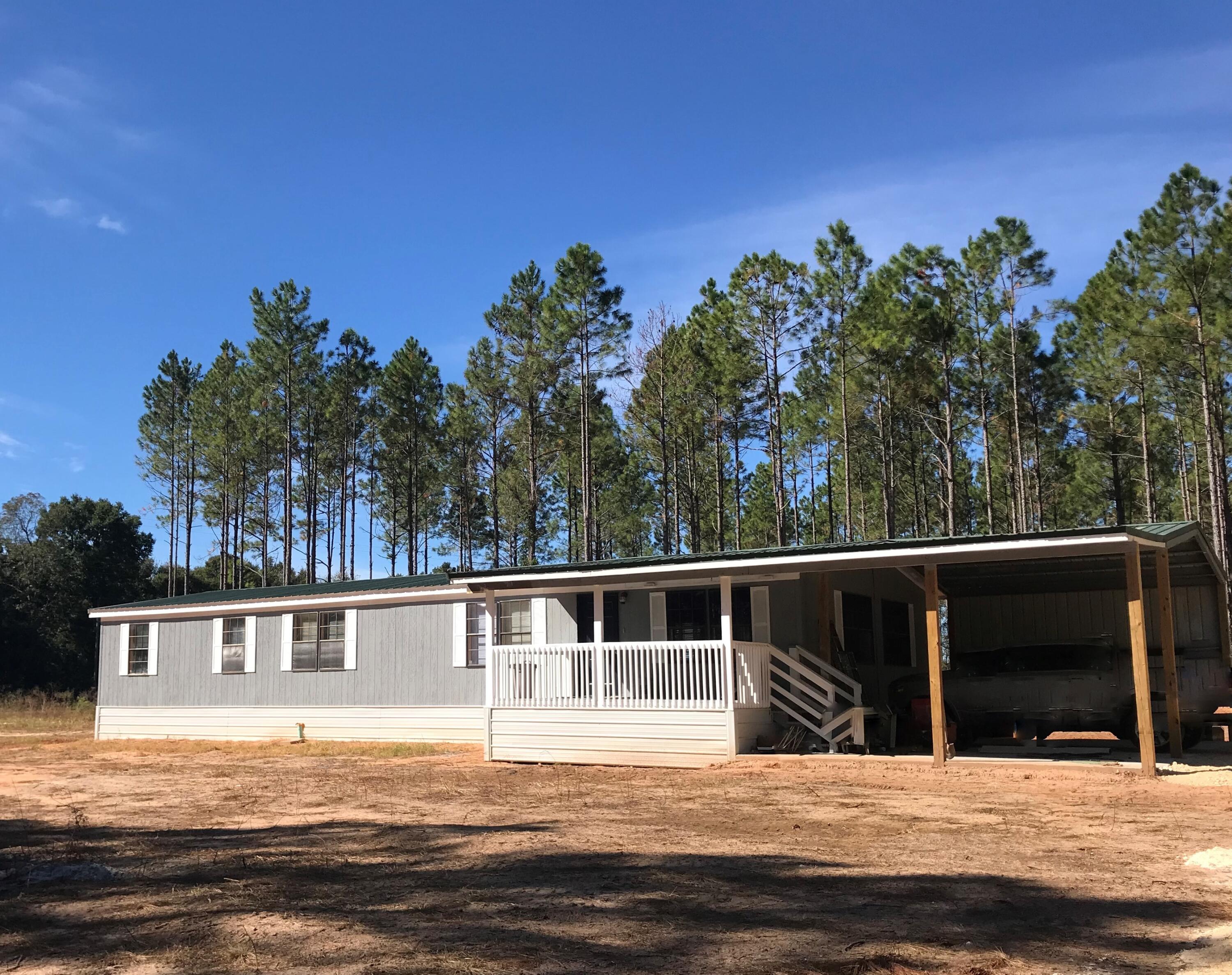 5806 Bush Road Baker, FL 32531 - Photo 17 of 17 a view of house with outdoor space and swimming pool