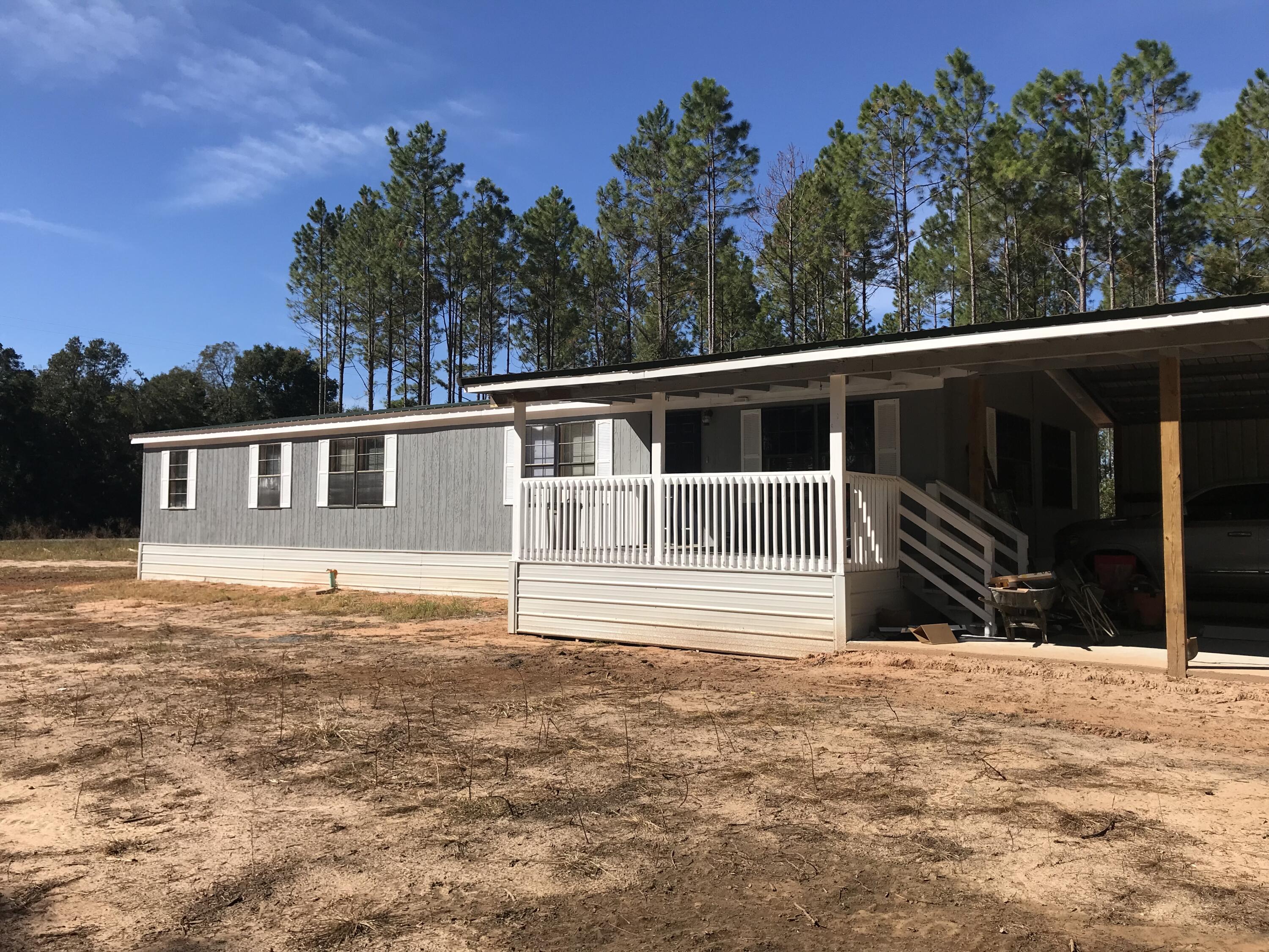 5806 Bush Road Baker, FL 32531 - Photo 2 of 17 a house view with a garden space