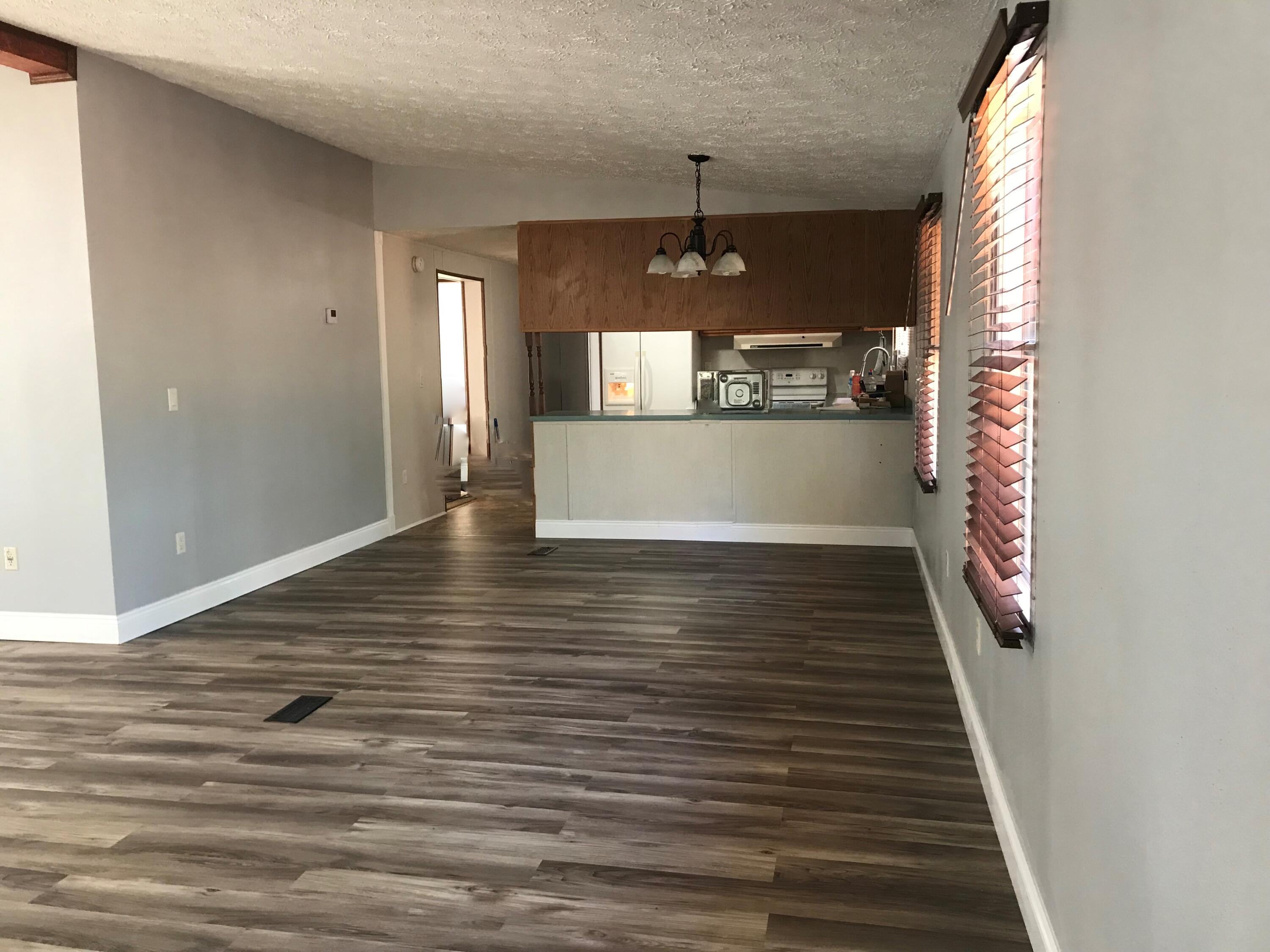 5806 Bush Road Baker, FL 32531 - Photo 4 of 17 a view of a room with wooden floor and staircase