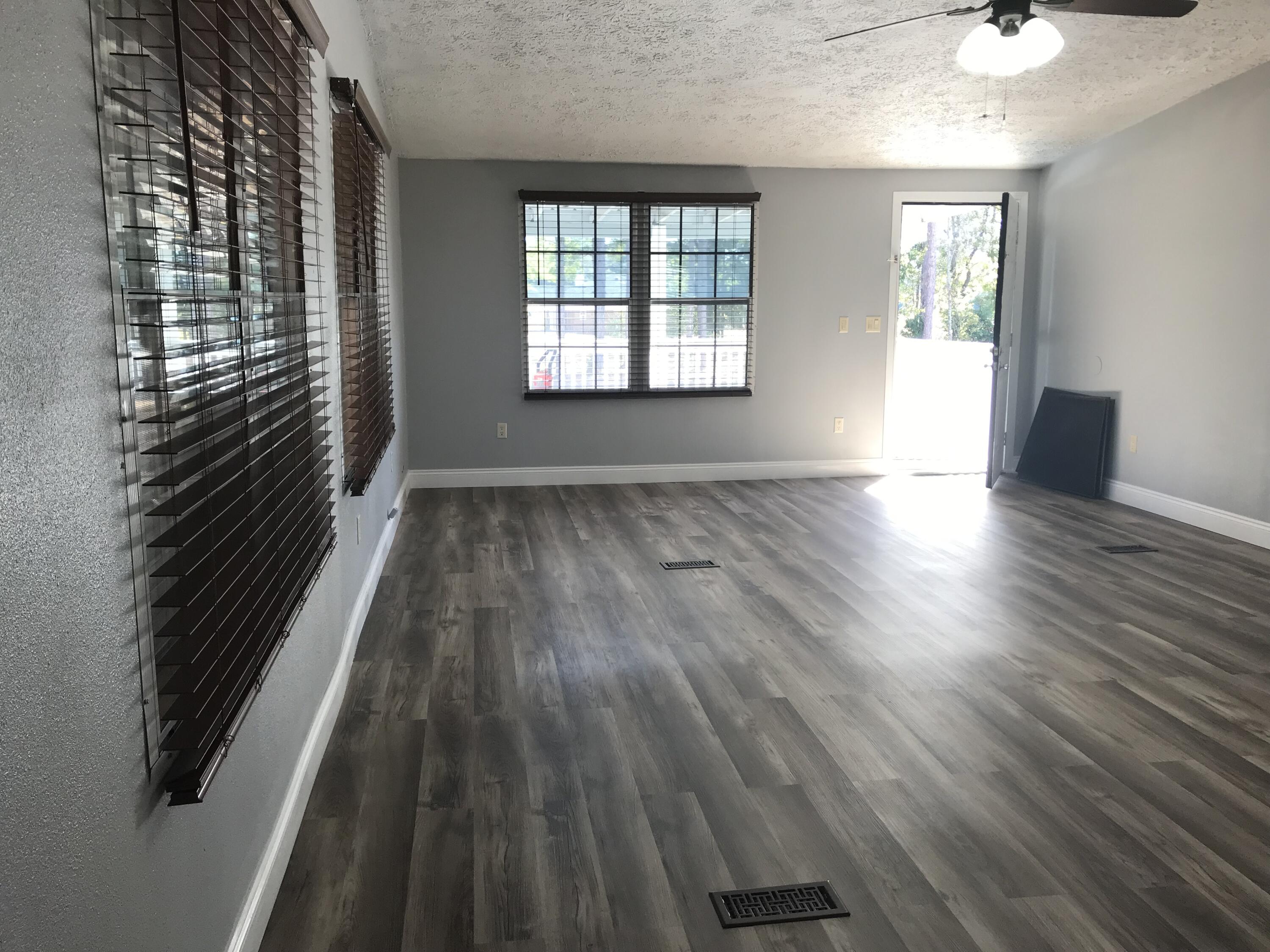 5806 Bush Road Baker, FL 32531 - Photo 5 of 17 wooden floor in an empty room with a window