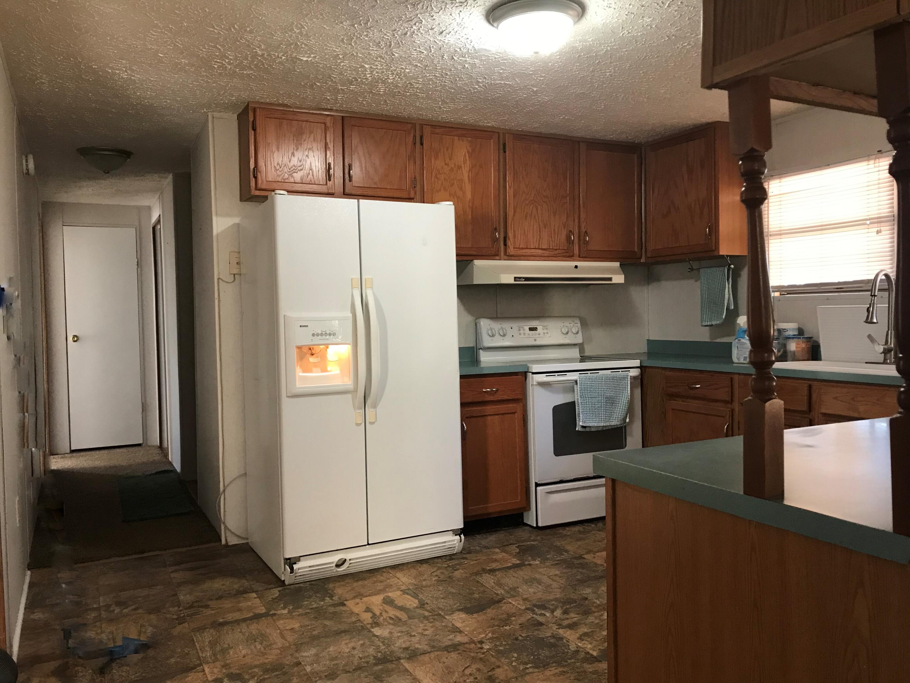 5806 Bush Road Baker, FL 32531 - Photo 7 of 17 a kitchen with a refrigerator sink and cabinets