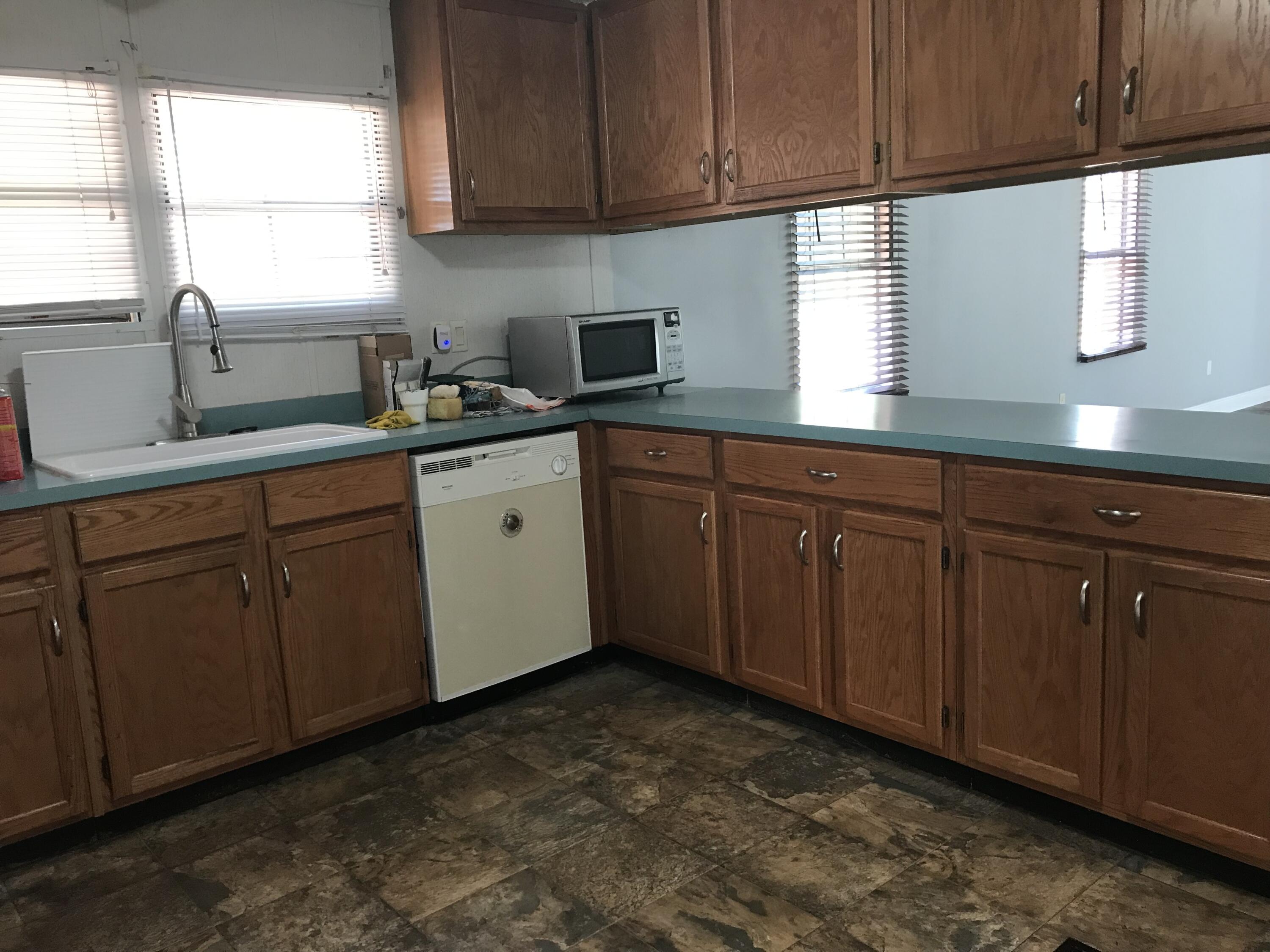5806 Bush Road Baker, FL 32531 - Photo 8 of 17 a kitchen with sink cabinets window and cabinets