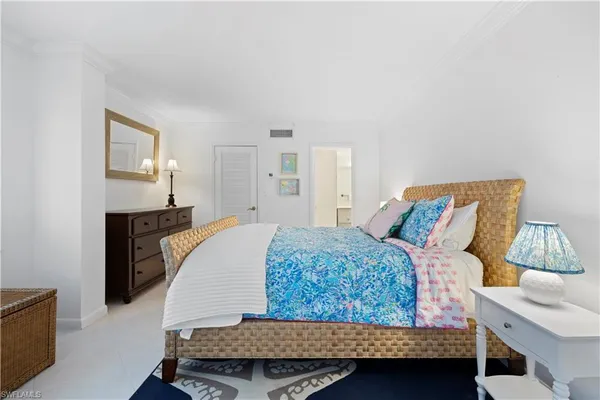 a bedroom with a bed and a night stand