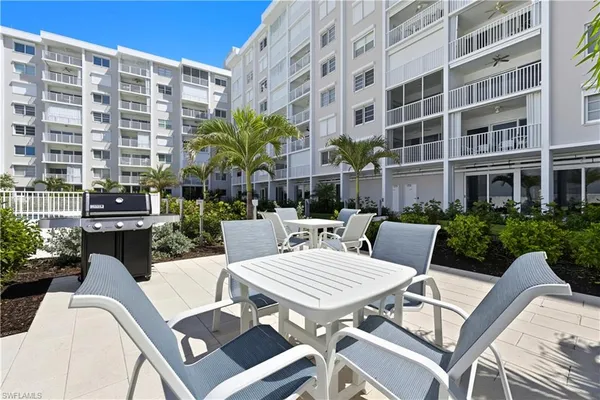 a swimming pool with outdoor seating
