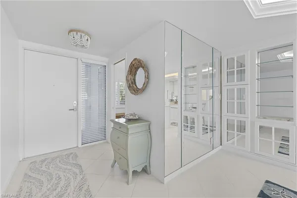 a spacious bathroom with a shower a mirror and a shower