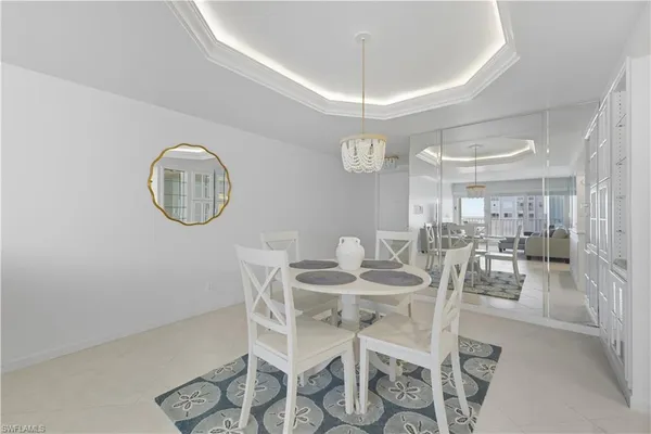 a view of a dining room with furniture and chandelier