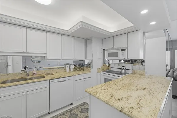 a kitchen with wooden cabinets sink and stove