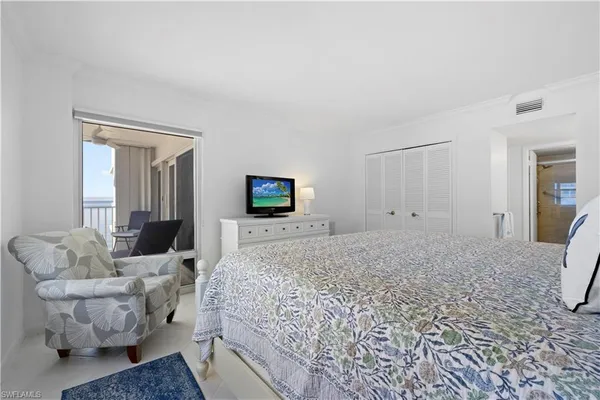 a spacious bedroom with a bed and couch