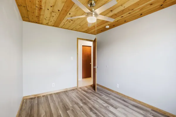 a view of hallway with a ceiling fan