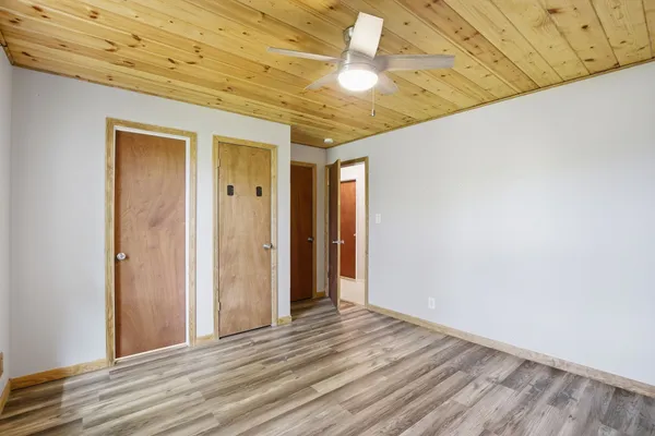 a view of a room with wooden floor