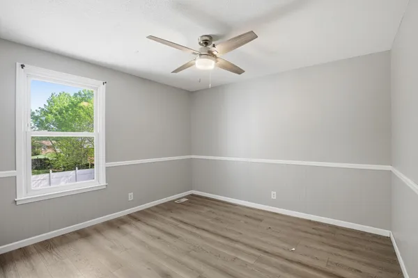 wooden floor in an empty room with a window