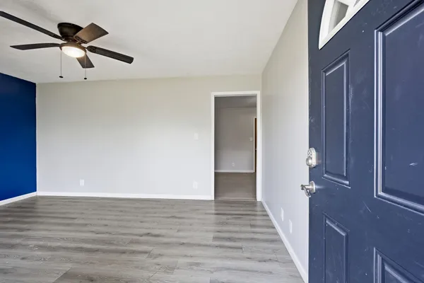 a view of a hallway with wooden floor