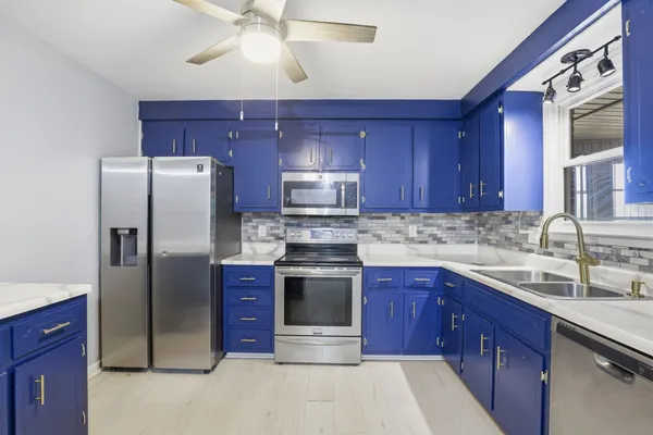 a kitchen with stainless steel appliances granite countertop a refrigerator stove a sink and dishwasher