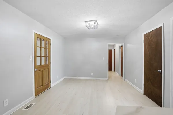 an empty room with windows and closet