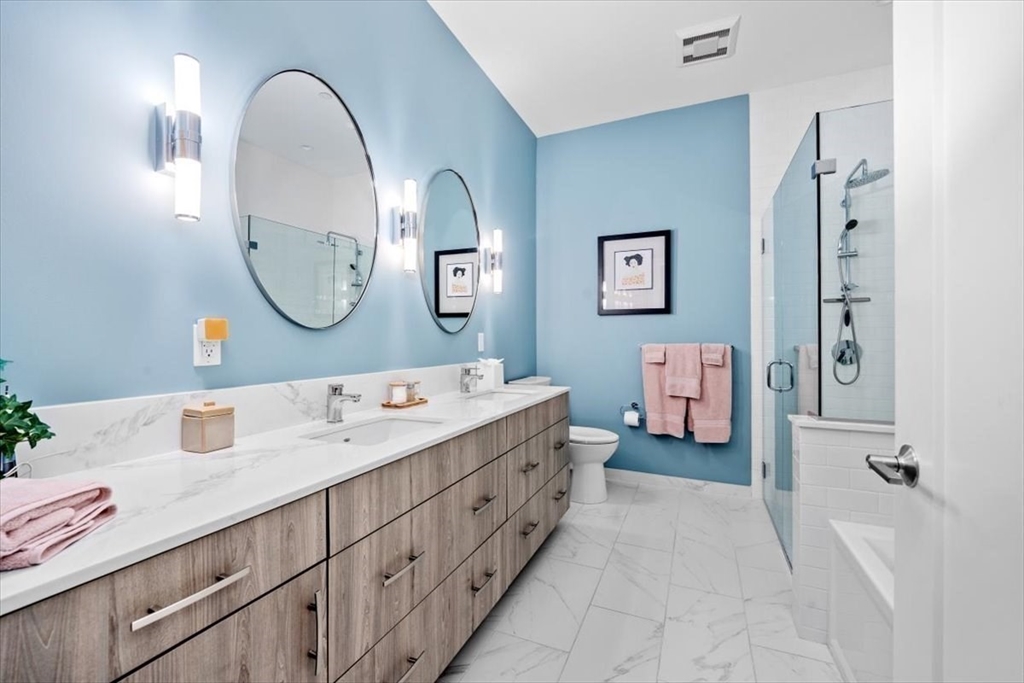 10 Shipyard Drive, Unit 312 Hingham, MA 02043 - Photo 19 of 32 a spacious bathroom with a double vanity sink and a mirror