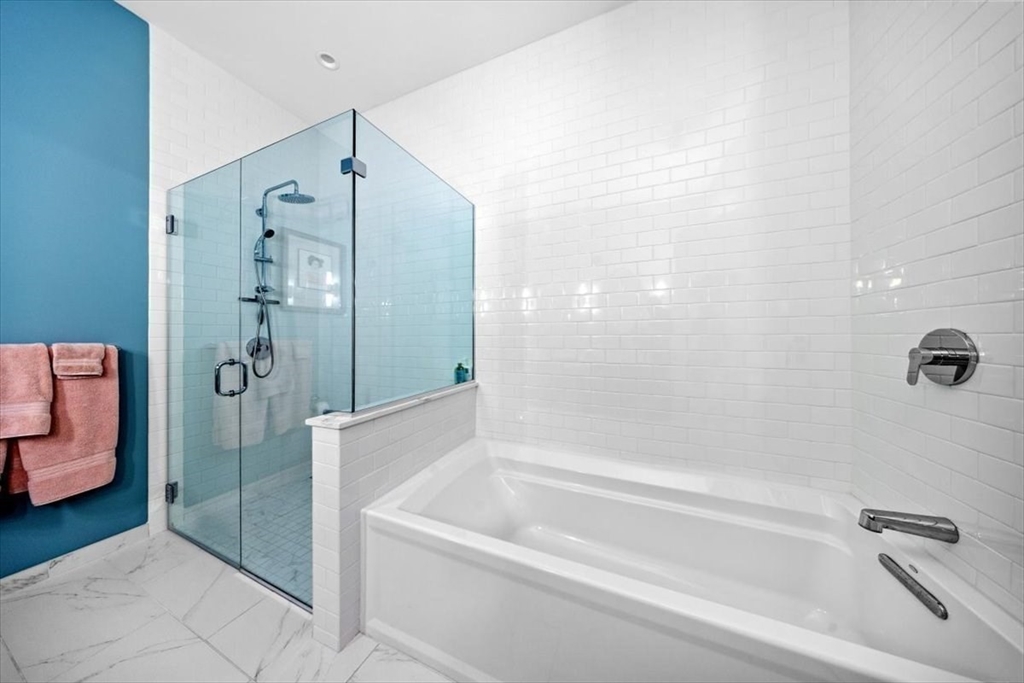 10 Shipyard Drive, Unit 312 Hingham, MA 02043 - Photo 20 of 32 a bathroom with a bathtub and a shower