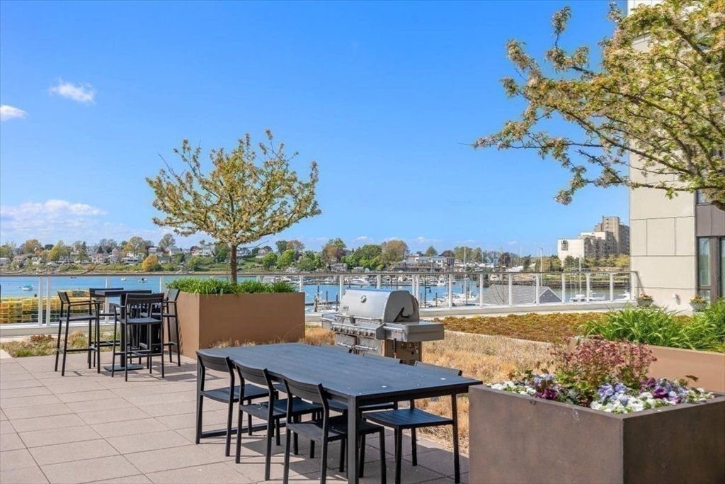 10 Shipyard Drive, Unit 312 Hingham, MA 02043 - Photo 29 of 32 a view of a chairs and table in a terrace