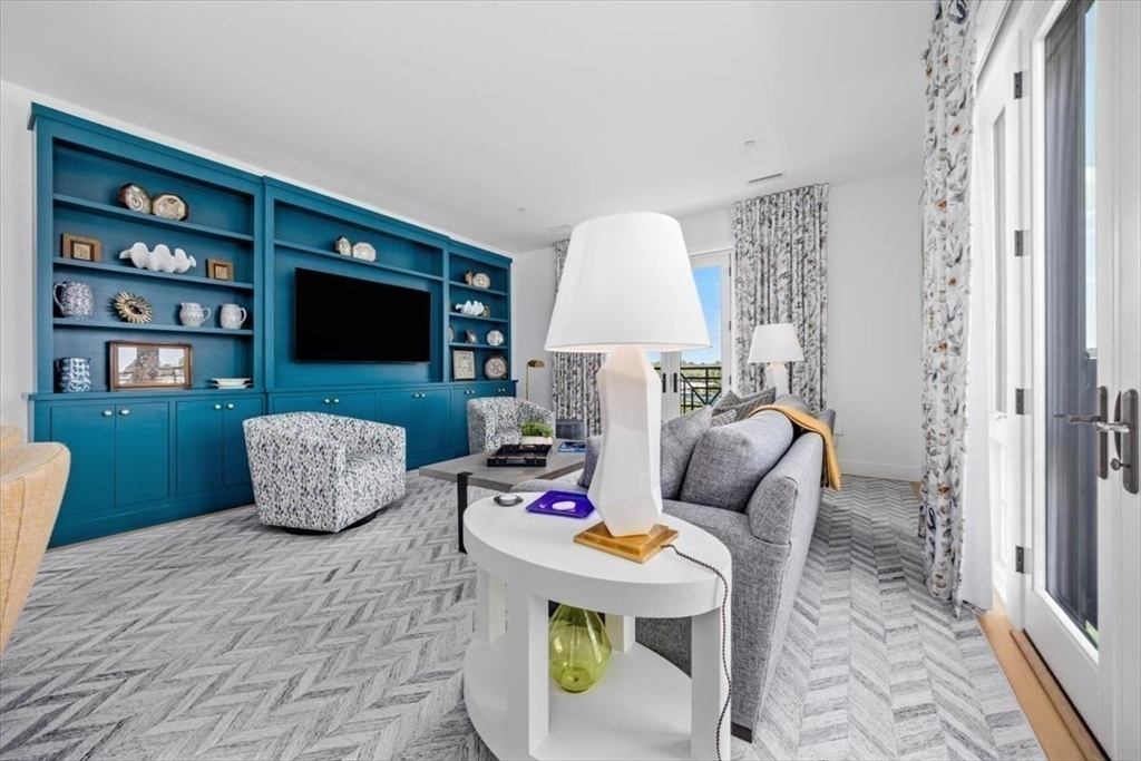 10 Shipyard Drive, Unit 312 Hingham, MA 02043 - Photo 4 of 32 a living room with furniture and a flat screen tv