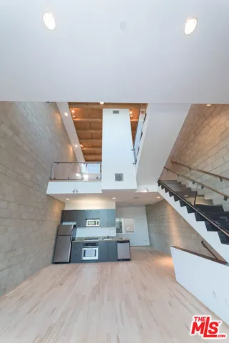 a view of a room with wooden floor
