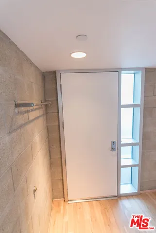 a view of a room with wooden floor and cabinet