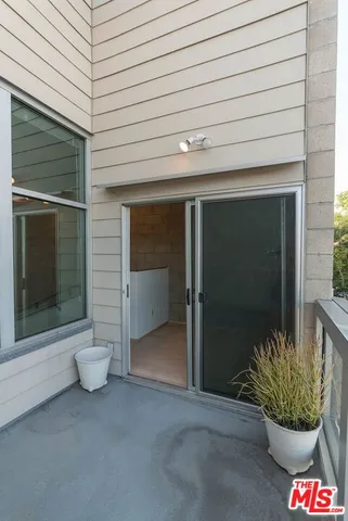a view of a porch with a door and a chair