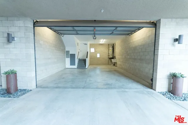 a view of a hallway with wooden shelves