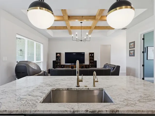 a view of a kitchen counter space and wooden floor
