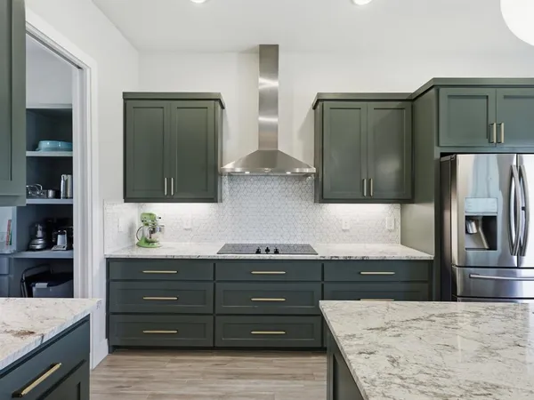 a kitchen with granite countertop cabinets and window