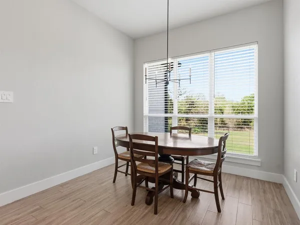 a spacious bedroom with a bed a chandelier and a window