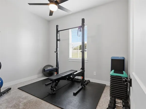 a view of a big house with a big yard and large trees