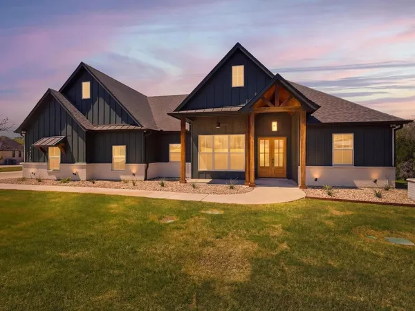 a front view of house with yard outdoor seating and garage