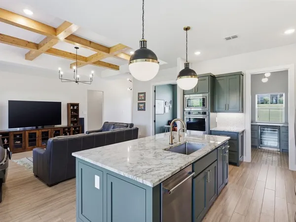 a kitchen with a table chairs and a flat screen tv