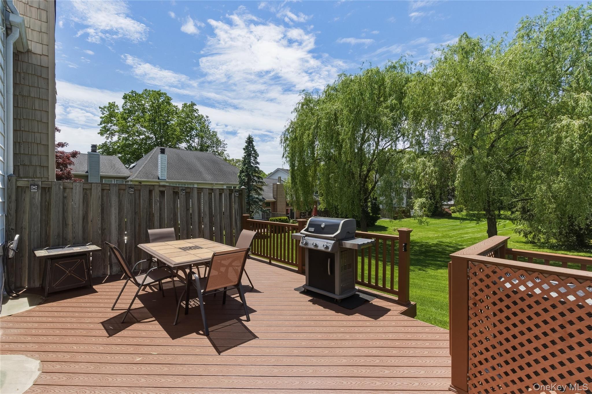 44 Hidden Ridge Drive Syosset, NY 11791 - Photo 18 of 28 a view of a dinning tables and chairs in the patio