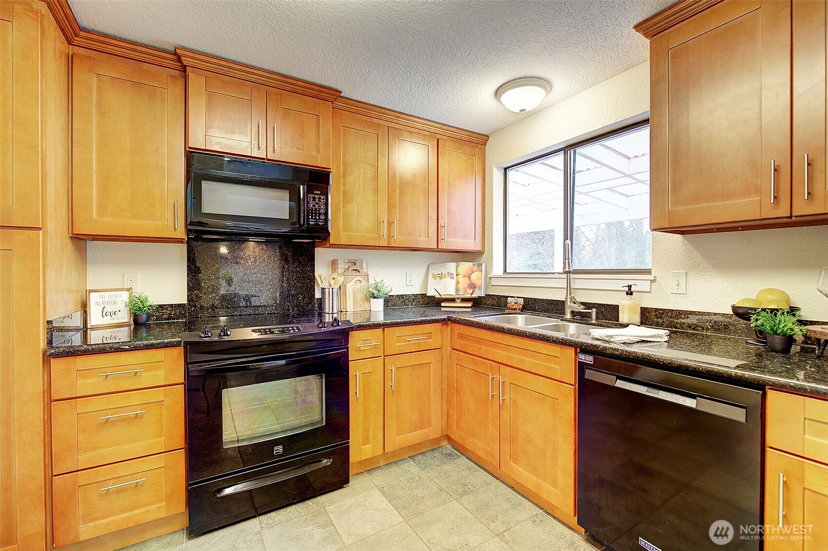 26229 197th Place Southeast Covington, WA 98042 - Photo 12 of 39 a kitchen with granite countertop cabinets stainless steel appliances a sink and window