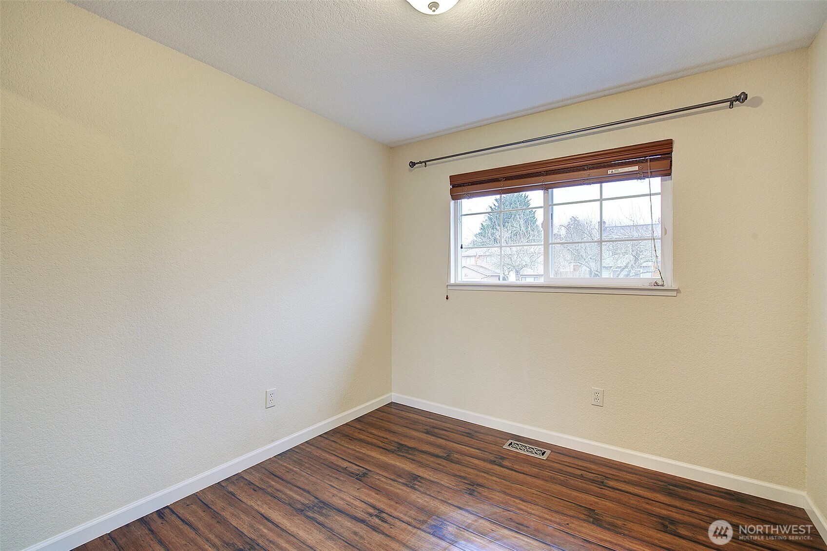 26229 197th Place Southeast Covington, WA 98042 - Photo 13 of 39 a view of an empty room with wooden floor and a window