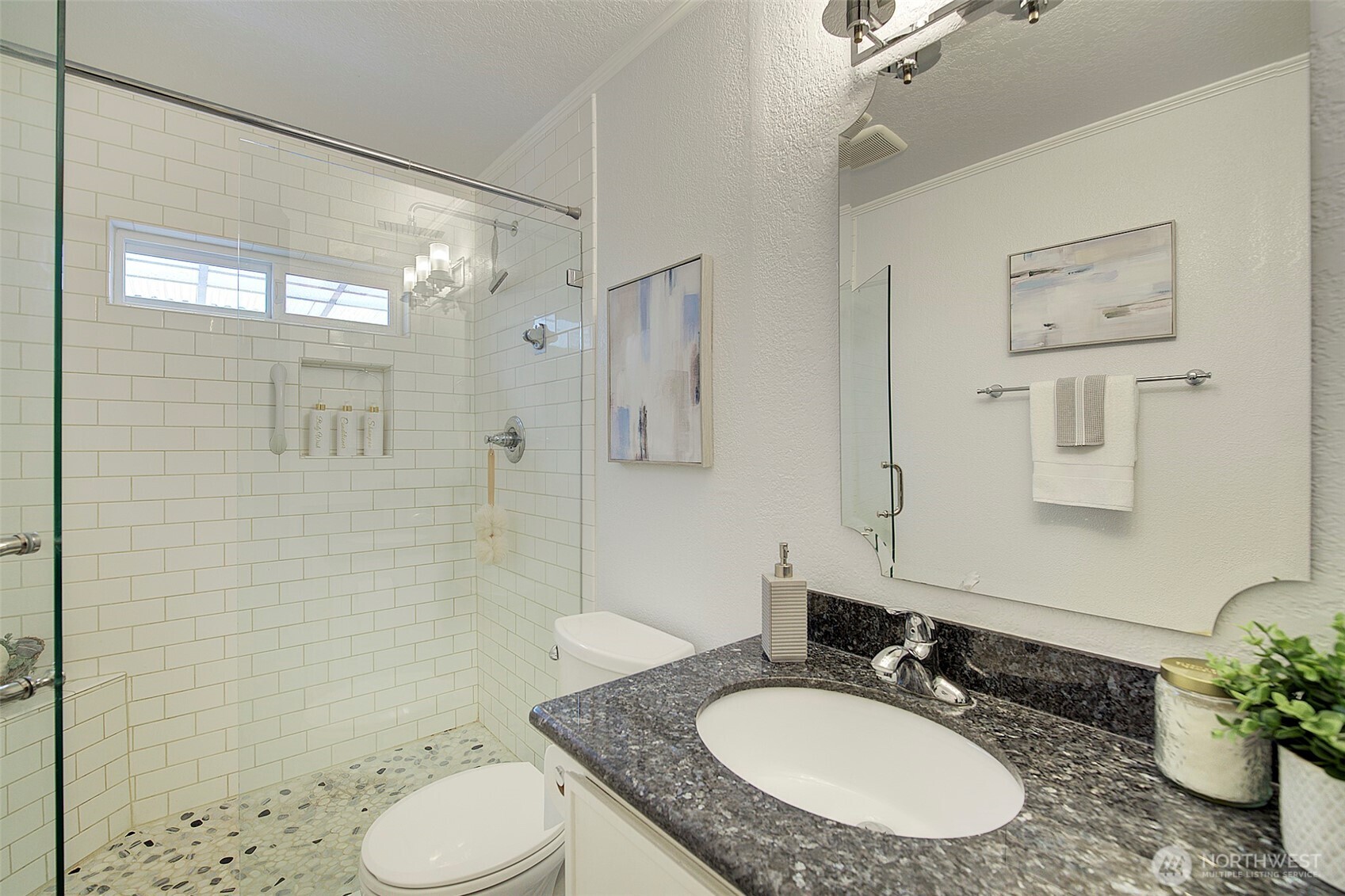 26229 197th Place Southeast Covington, WA 98042 - Photo 17 of 39 a bathroom with a granite countertop sink toilet a mirror a shower and a bathtub