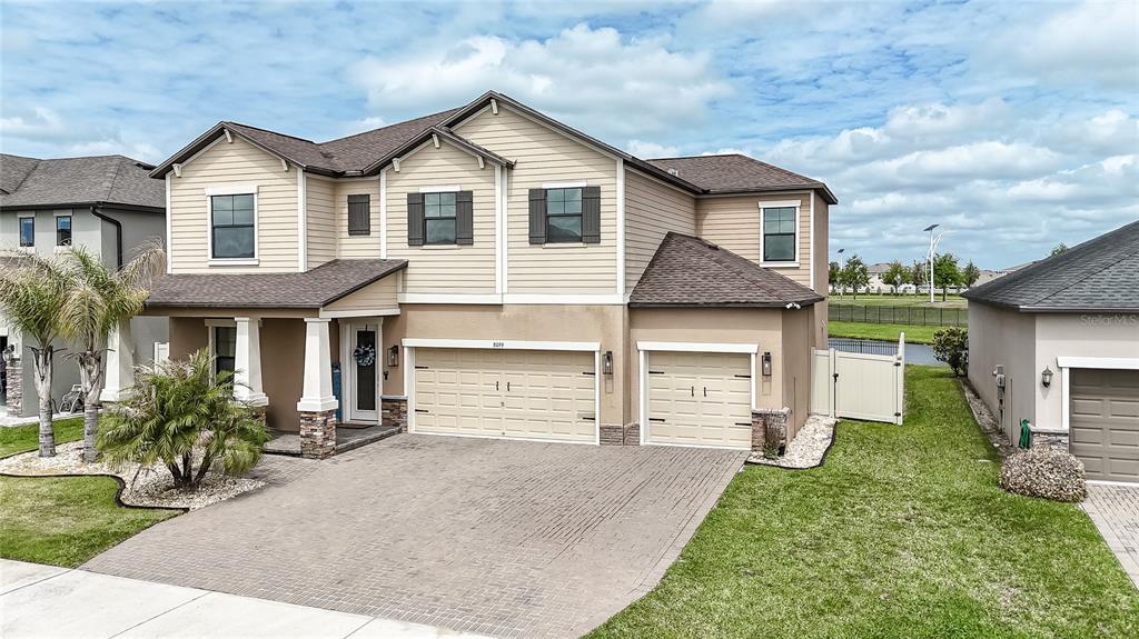 8099 Lago Mist Way Wesley Chapel, FL 33545 - Photo 1 of 56 a front view of a house with a yard and garage