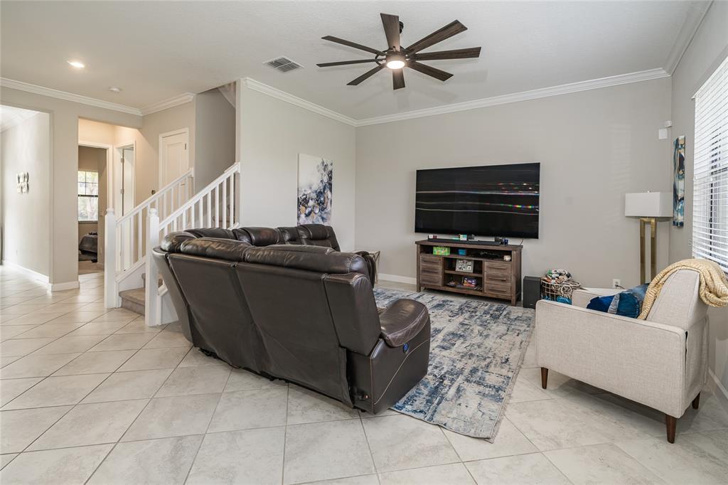 8099 Lago Mist Way Wesley Chapel, FL 33545 - Photo 13 of 56 a living room with furniture and a flat screen tv